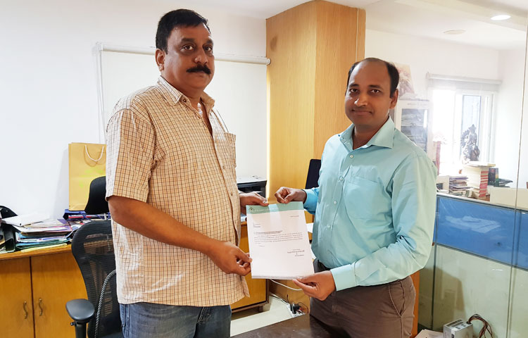 Managing Director presents an appreciation letter to Designer Ashok